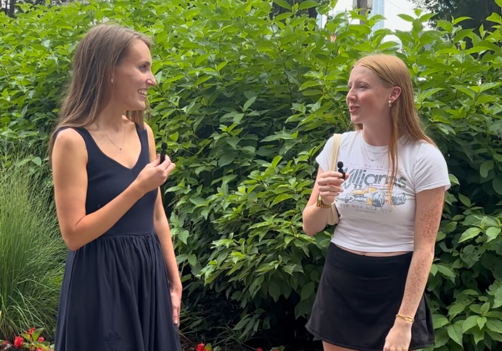 A woman interviewing a girl on the street about her shower routine, including how often she washes her hair and how she shampoos and conditions her hair.