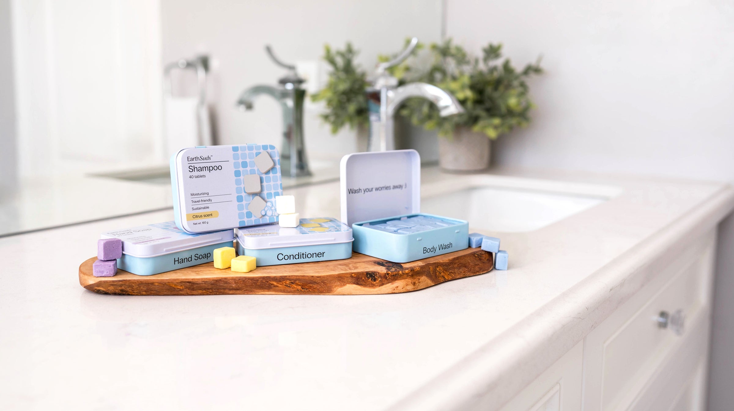 Sustainable travel shampoo, conditioner, body wash, and hand soap tablets on countertop.