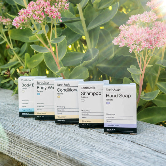 EarthSuds travel packs including shampoo, conditioner, body wash, hand soap, and body butter.