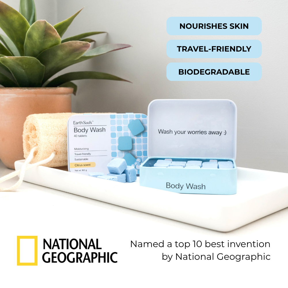 Travel body wash tablets with reusable case on countertop beside eco-friendly body wash tablets and brush.