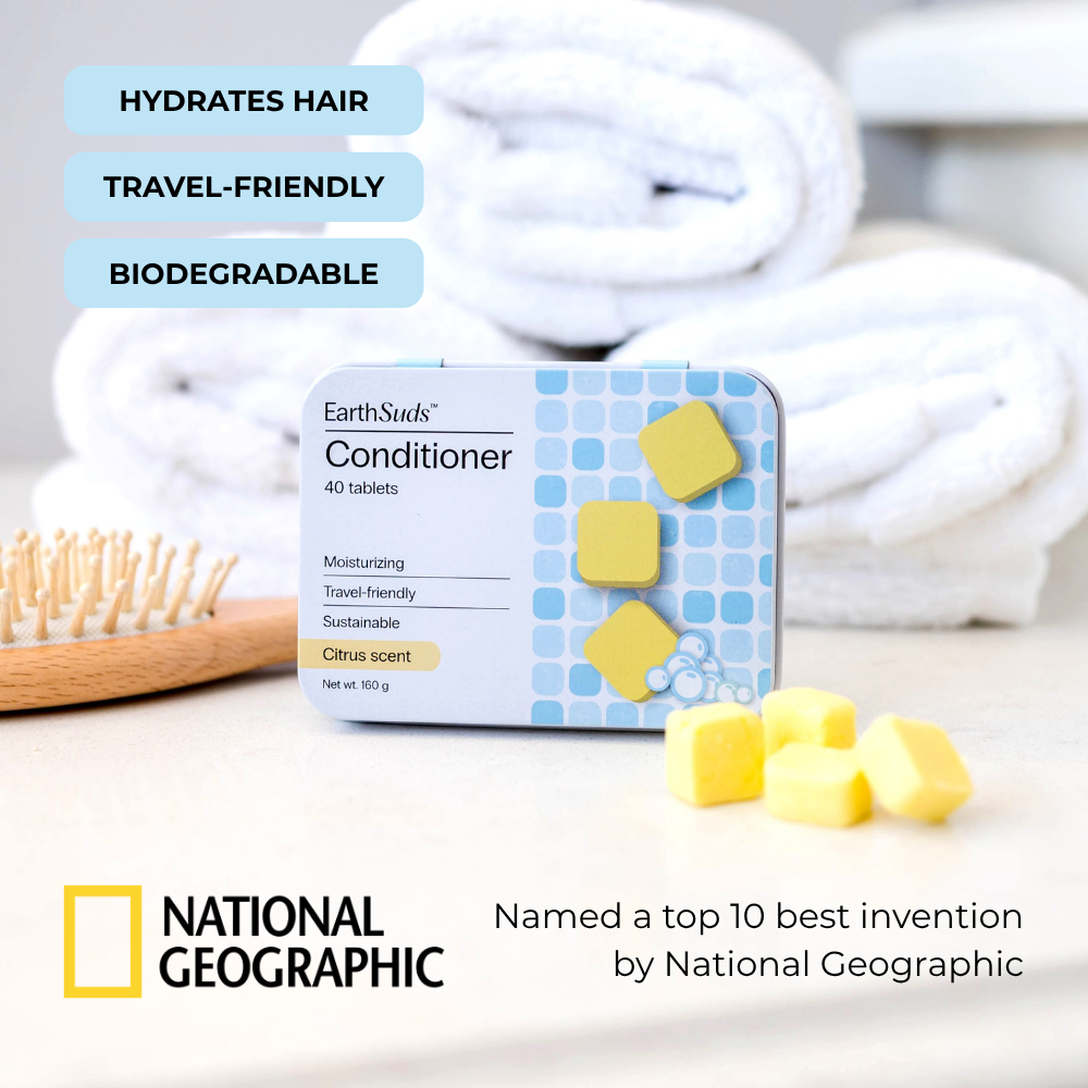 Travel conditioner tablets with reusable case on countertop beside eco-friendly conditioner tablets and brush.