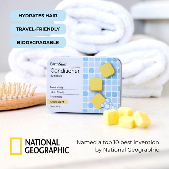 Travel conditioner tablets with reusable case on countertop beside eco-friendly conditioner tablets and brush.