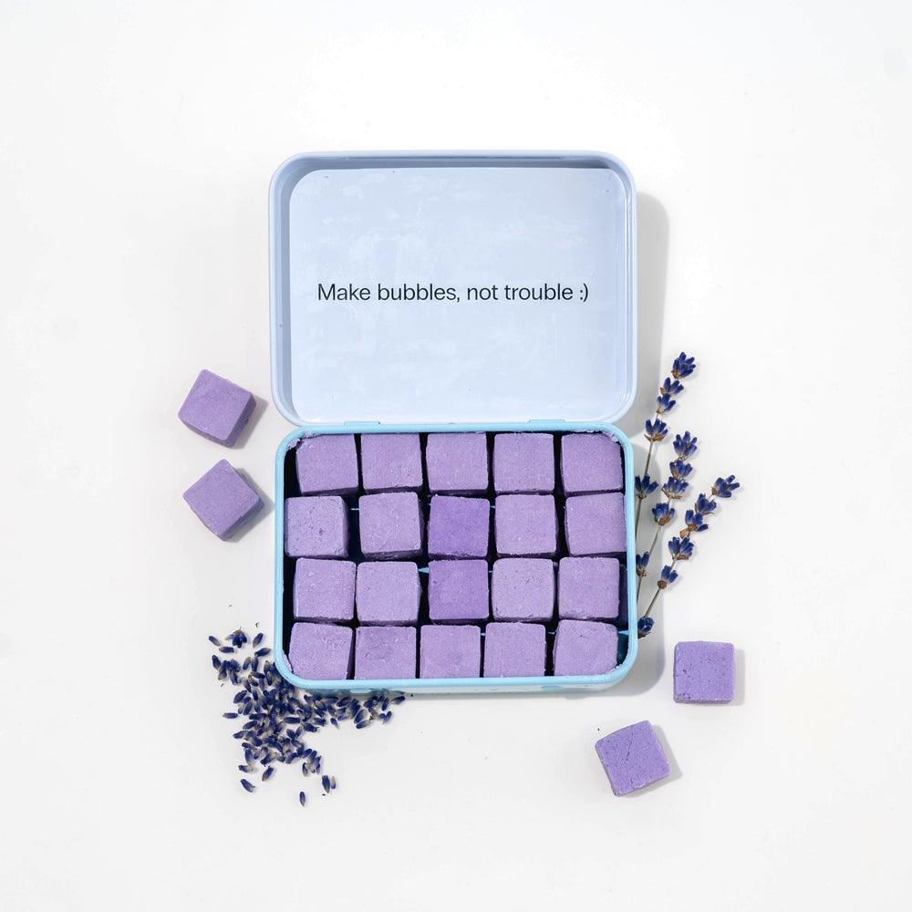 Travel hand soap pack with dissolvable, biodegradable hand soap tablets and lavender around it.