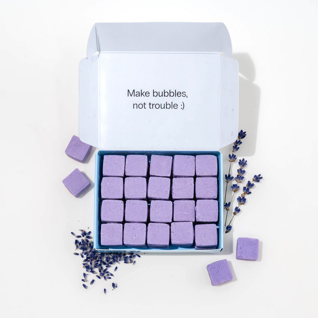 Travel hand soap pack with dissolvable, biodegradable hand soap tablets and lavender around it.