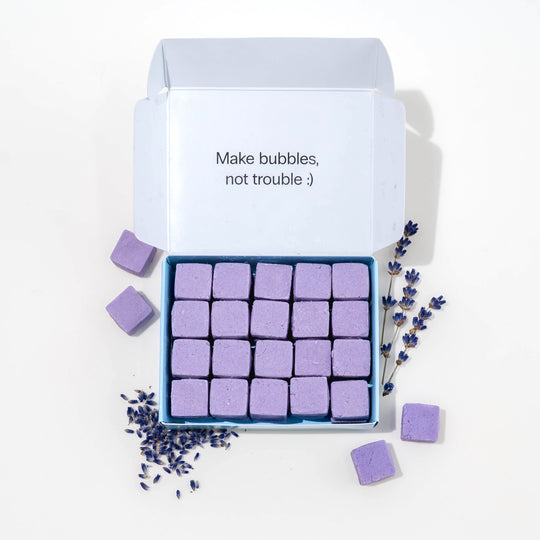 Travel hand soap pack with dissolvable, biodegradable hand soap tablets and lavender around it.