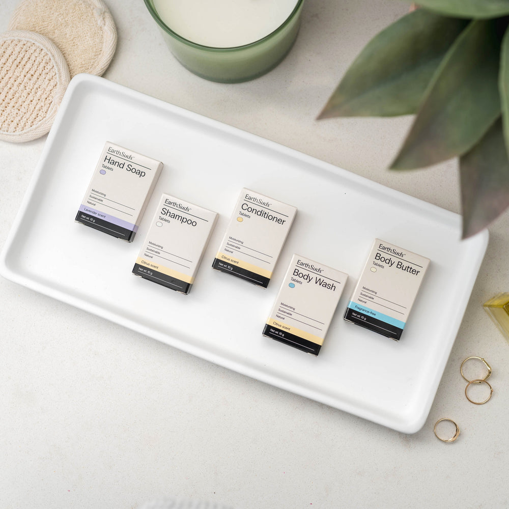 EarthSuds travel packs including shampoo, conditioner, body wash, hand soap, and body butter.