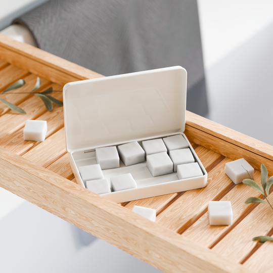 EarthSuds sustainable travel toiletries; body butter tablets in carry-on friendly packaging.