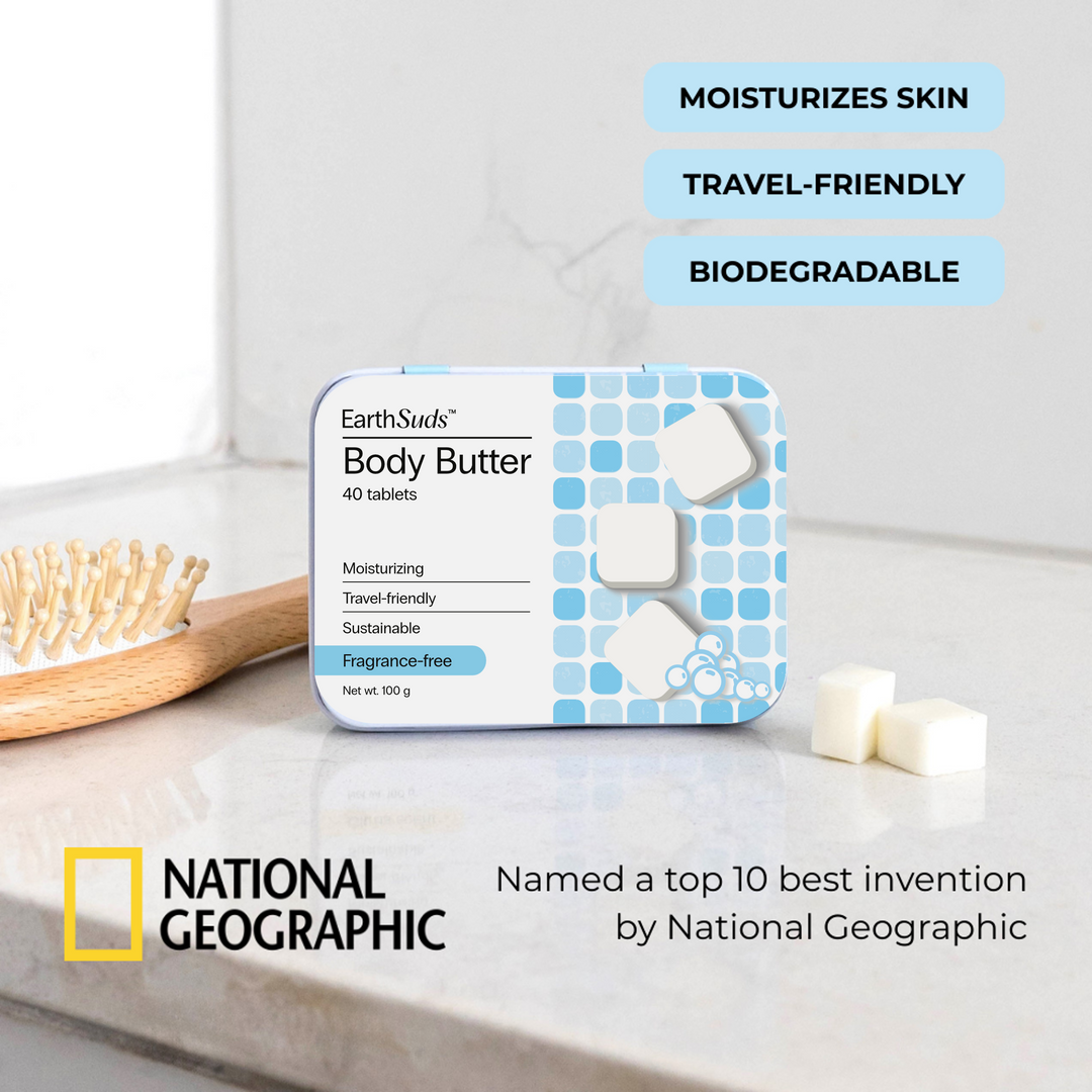 Travel body butter tablets with a reusable case on a countertop beside eco-friendly body butter tablets and brush.