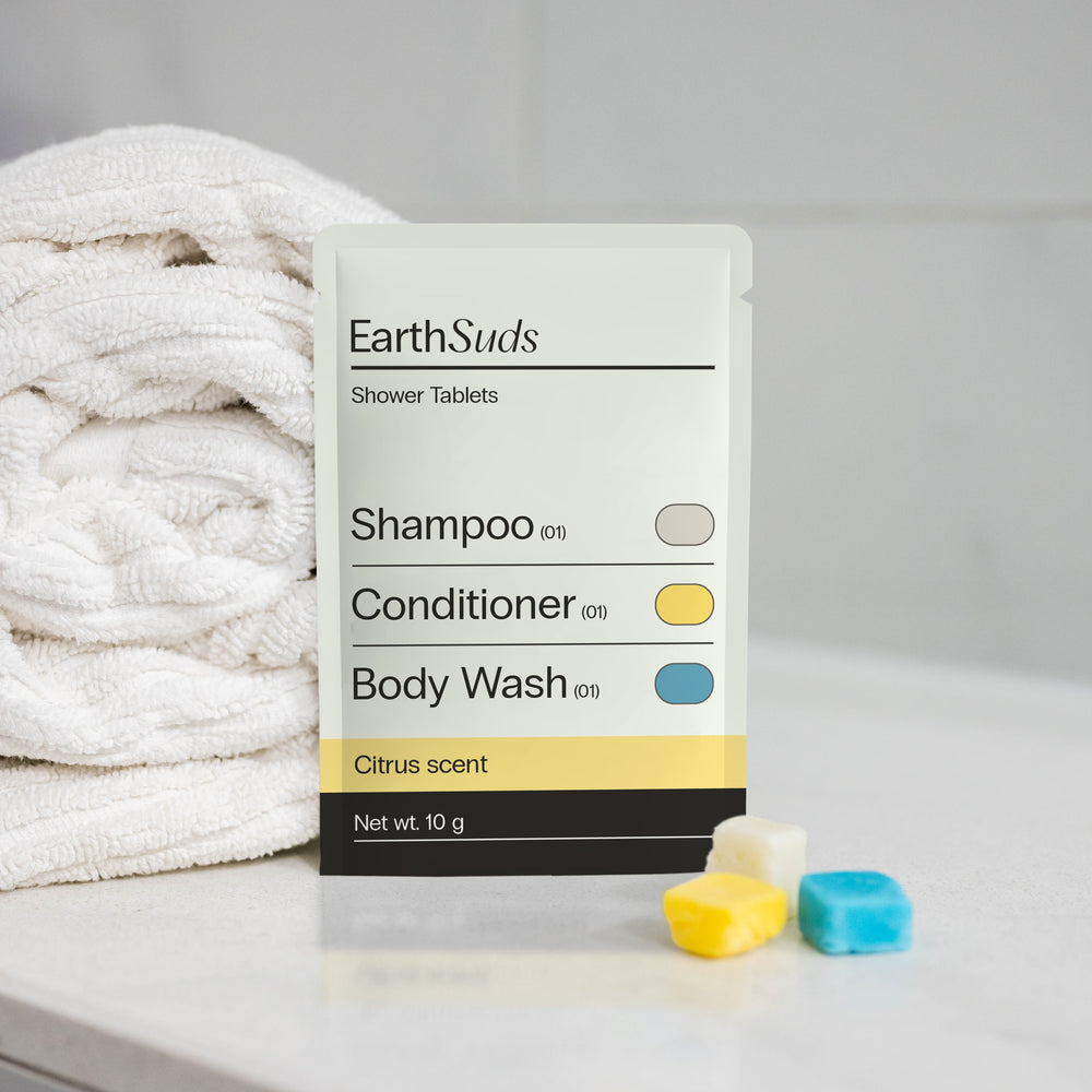 Sustainable shampoo, conditioner, and body wash tablets in a compostable pack.