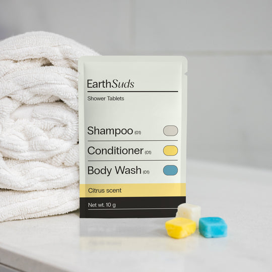 Sustainable shampoo, conditioner, and body wash tablets in a compostable pack.