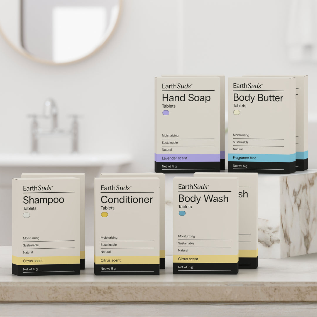 EarthSuds Mini Packs including shampoo, conditioner, body wash, hand soap, and body butter on a bathroom counter.