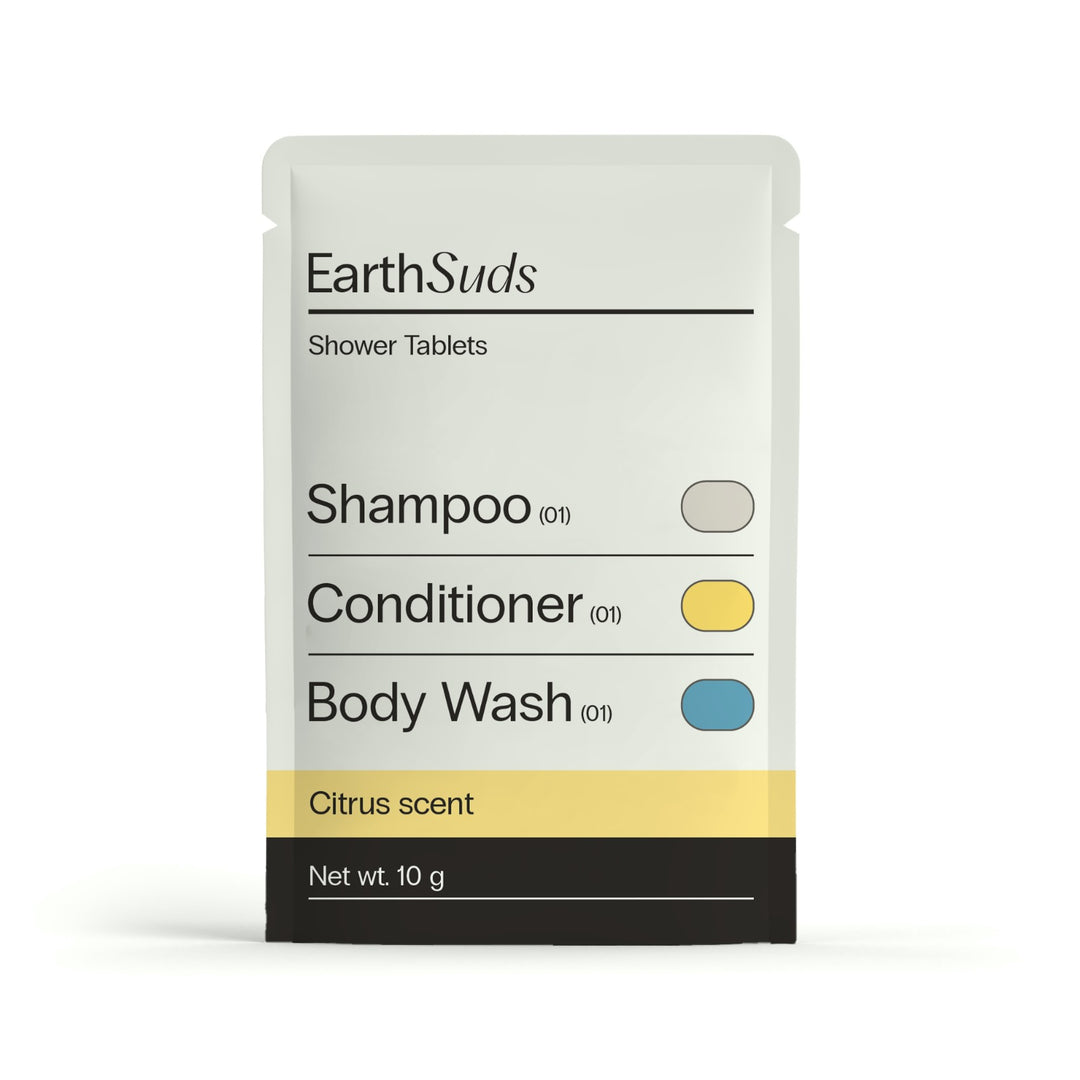 EarthSuds shower tablet packaging on a white background containing shampoo, conditioner, and body wash in citrus scent