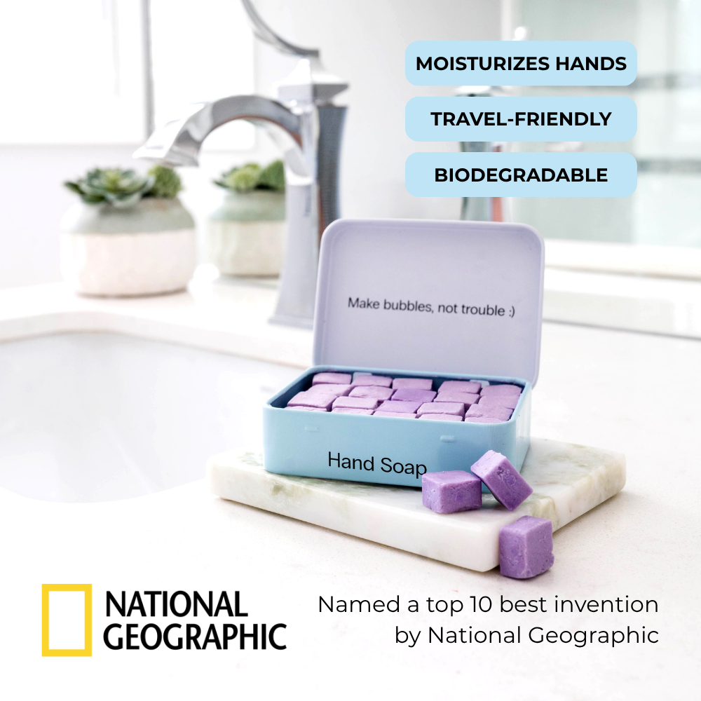 Travel hand soap tablets with reusable case on countertop beside eco-friendly hand soap tablets and brush.