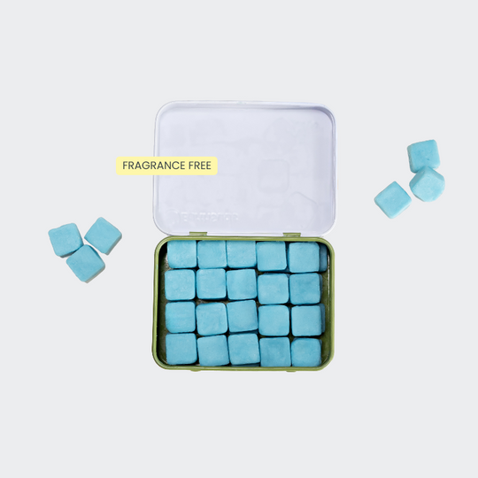 Travel body wash with blue tablets in a reusable case that's plastic-free and sustainable.