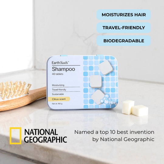 Travel shampoo tablets with reusable case on countertop beside eco-friendly shampoo tablets and brush.